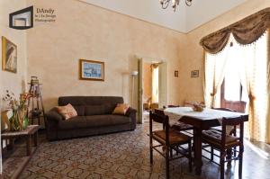 a living room with a couch and a table at Etna in Belpasso