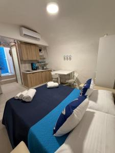a bedroom with a blue and white bed with pillows at Maja cuore blu in Vieste +1 photo