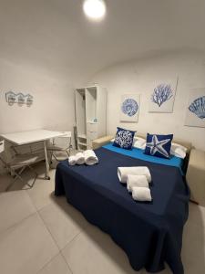 a bedroom with a blue bed with towels on it at Maja cuore blu in Vieste