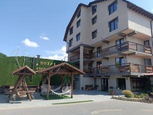 a hotel with a playground in front of it at Hotel Racu Family in Komrat