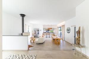 a living room and dining room with white walls at Vila Adelino in Sines