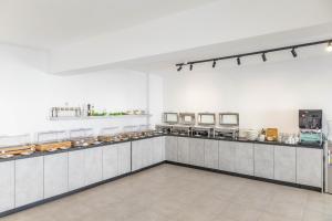 a large kitchen with a counter in a room at Santorini View in Akrotiri