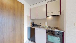 a kitchen with a sink and a stove at Bright studio in Saillon, a few steps from Les Bains in Saillon +7 photos
