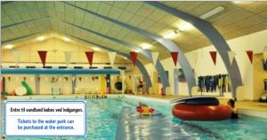 a large swimming pool with a red raft in it at Thyregod Kursuscenter in Thyregod