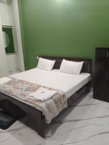 a bed with two pillows on it in a room at Ayodhya Stay in Ayodhya +20 photos
