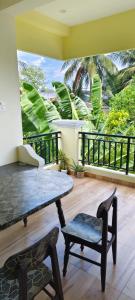 a room with a table and a chair on a balcony at Ecstasy Homestay Puducherry in Pondicherry