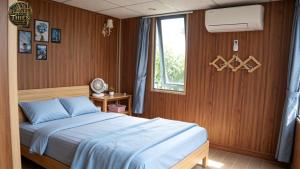 a bedroom with a bed and a window at Cổ Thiên Thạch Kiếm in Ðại Lào