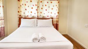 a bedroom with a bed with towels on it at Auki Ocean View in Auki