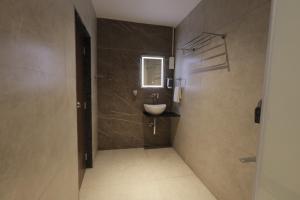 a bathroom with a sink and a mirror at Hotel Krushnai Deluxe in Nandre
