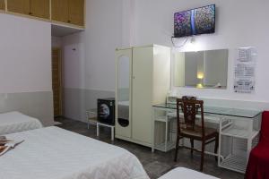 a room with two beds and a desk with a chair at QUANG SAIGON Hotel- 40-7 Bùi Viện-Walking street in Ho Chi Minh City