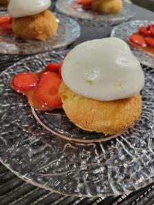 a plate of food with strawberries on a table at Le Panoramic Garabit in Anglards-de-Saint-Flour