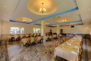 a banquet hall with tables and chairs in a room at Aangan Resort Mandawa in Mandāwa