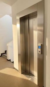 an elevator in a building with a metal door at Vista Mare a Isola Verde in Isola Bacucco