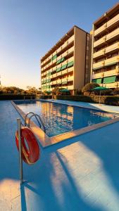 a swimming pool with a red slide in front of a building at Vista Mare a Isola Verde in Isola Bacucco