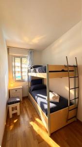 a bedroom with two bunk beds and a window at Vista Mare a Isola Verde in Isola Bacucco +26 photos