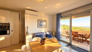 a living room with a table and a view of the ocean at Vista Mare a Isola Verde in Isola Bacucco