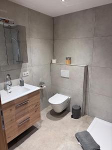 a bathroom with a toilet and a sink at Haus Bodner in Kartitsch