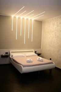 a bedroom with a bed with two towels on it at ASTRUM b&b in Cosenza