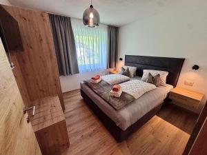 a bedroom with a bed and a large window at Haus Bodner in Kartitsch
