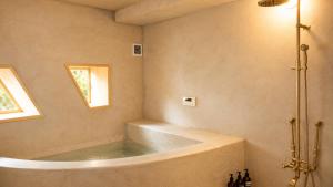 a bath tub in a bathroom with a window at Villa KULM in Minamiawaji