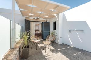 a patio with chairs and plants in a building at Tholos Home Sfakia in Hora Sfakion