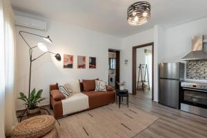 a living room with a couch and a kitchen at Tholos Home Sfakia in Hora Sfakion