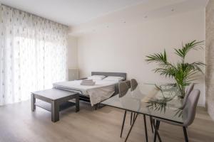 a bedroom with a bed and a table and a plant at Bergamo Hideout in Bergamo