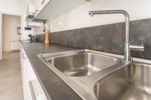 a stainless steel sink in a stainless steel kitchen at Bergamo Hideout in Bergamo +22 photos