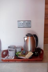 a tray with a coffee pot and cups on it at Area 51 Arugambay in Arugam Bay +17 photos
