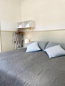 a bedroom with a bed with two pillows on it at Lundsgaard Gods ferielejlighed in Kerteminde +7 photos
