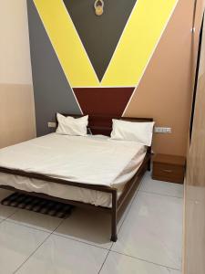 a bed in a room with a striped wall at The Urban Lodge in Goriān