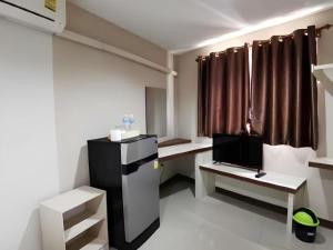 a room with a room with a tv and a room with a room at Poompimaan House in Udon Border Police