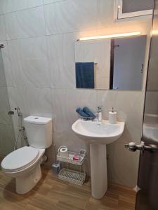 a bathroom with a white toilet and a sink at Casa Solare in Wellawatta +41 photos