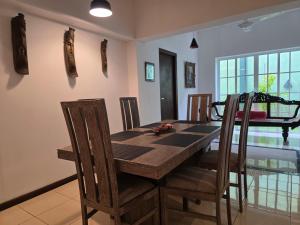a dining room with a wooden table and chairs at Casa Solare in Wellawatta