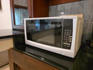 a microwave oven sitting on top of a counter at Casa Solare in Wellawatta