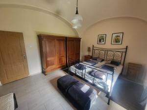a bedroom with a bed and a wooden cabinet at ubytovaní na statku 