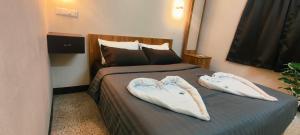 a hotel room with two towels on a bed at COCHIN CINEMA Rooms in Cochin