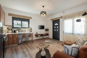 a living room with a couch and a kitchen at Tholos Home Sfakia in Hora Sfakion +12 photos