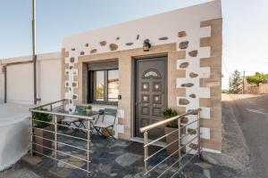 a house with a wooden door and a balcony at Tholos Home Sfakia in Hora Sfakion