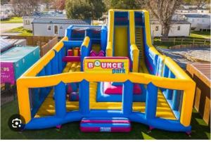 a colorful play set in a yard at Family friendly caravan park in Little Clacton