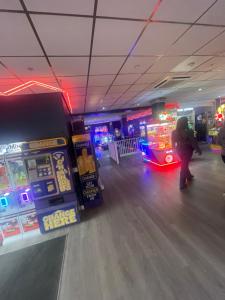a person playing a video game in a bowling alley at Family friendly caravan park in Little Clacton