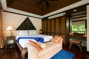 a bedroom with a bed and a couch and a window at Katamanda Villa Chanti Pool Villa Kata in Kata Beach +61 photos