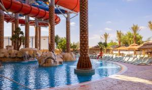 a water slide at a resort with a water park at Kassland Resort & Spa -By Kassland Hotels in Ma'ale Adumim