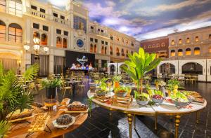 a hotel lobby with tables of food and plants at Kassland Resort & Spa -By Kassland Hotels in Ma'ale Adumim