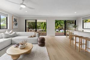 a living room with a couch and a table at Blue Gum Hideaway Pet friendly Fire Pit in Coolum Beach