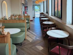 a row of tables and chairs in a restaurant at Railway Hotel in Wellington