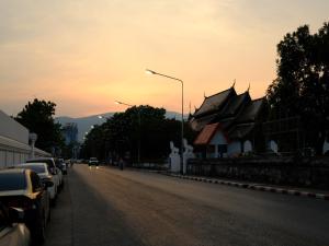 a street with cars parked on the side of a road at Maison Dang Boutique Hotel in Chiang Mai