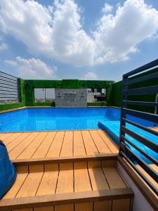 a large swimming pool with a wooden deck at Hotel Next View Amritsar # Pool # Parking # Family Hotel # Best choice for Tourists in Amritsar