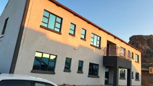 a building with a balcony on the side of it at Solomon Guest House in Maseru