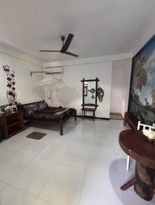 a living room with a bed and a table at Lobster Inn in Trincomalee